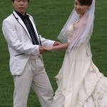 Groom and Bride Being Photographed Against Chateau Chengyu Background