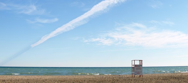 Long Contrail Over the Beach