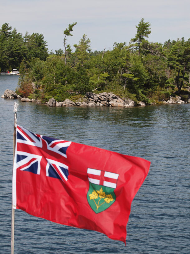 Ship's Flag with Rugged Island in Background